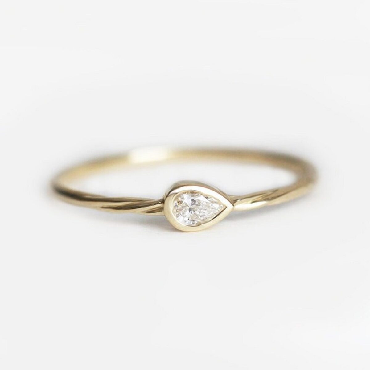 Minimal vintage style bezel set 3*2 mm pear cut lab grown diamond solitaire ring crafted in 14k yellow gold.