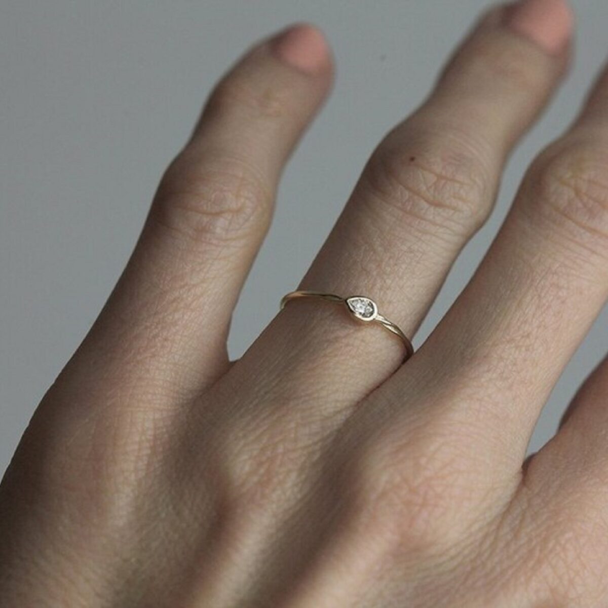 Minimal vintage style bezel set 3*2 mm pear cut lab grown diamond solitaire ring crafted in 14k yellow gold.