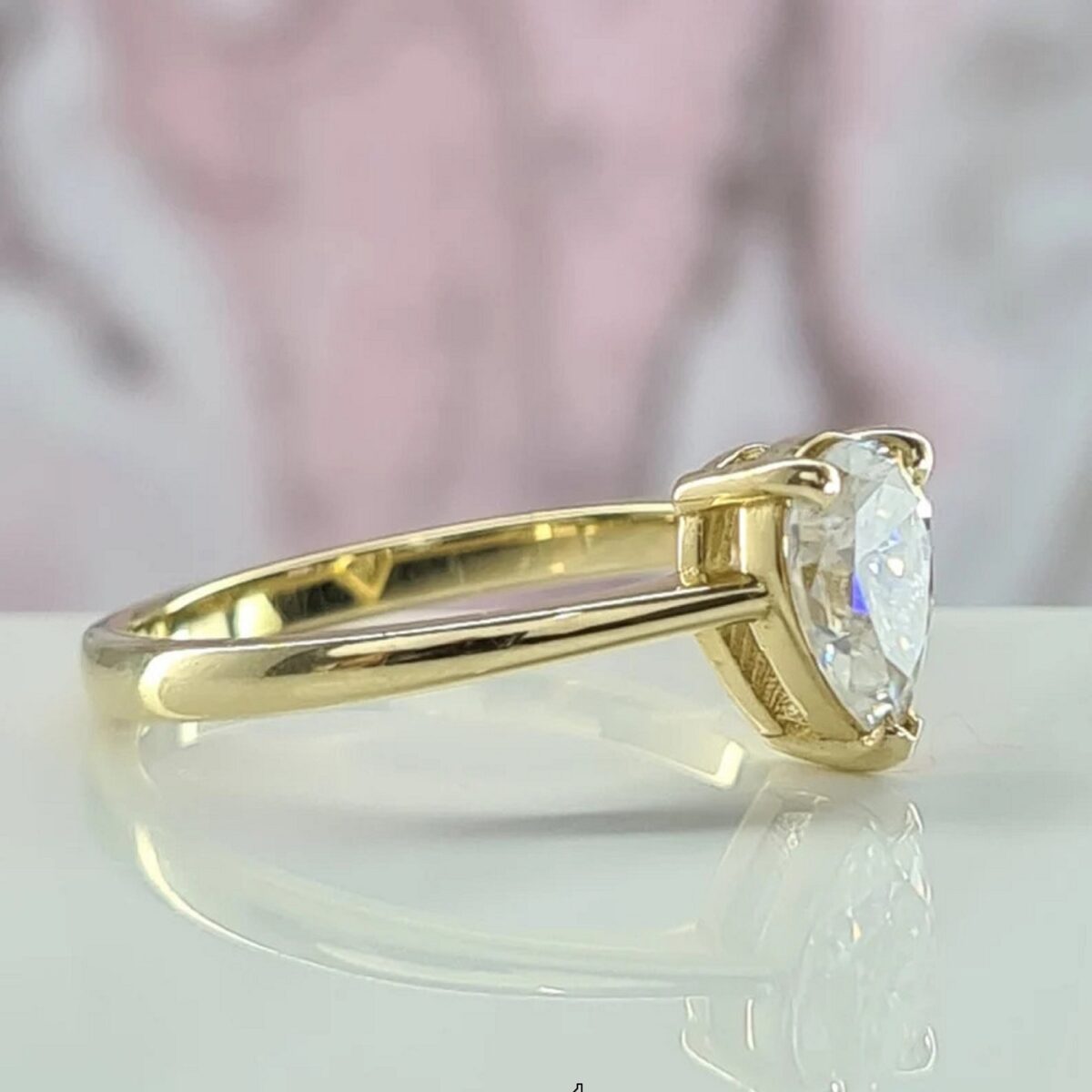 Minimal teardrop pear lab grown diamond ring for bridal crafted in 14k yellow gold..