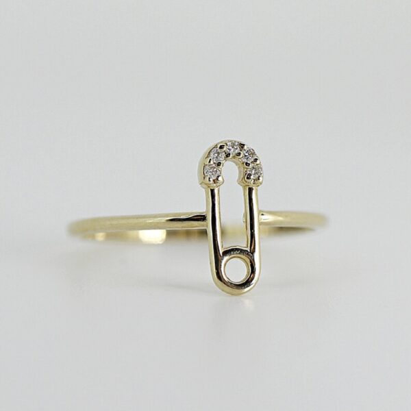Unique, modern, minimal, safety pin shaped round cut lab grown diamond ring crafted in 14k solid yellow gold