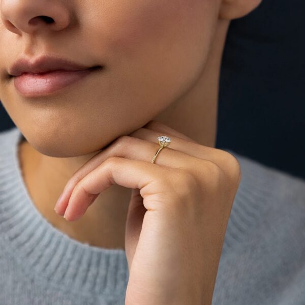 Round cut lab grown diamond solitaire engagement ring crafted in 14k yellow gold.