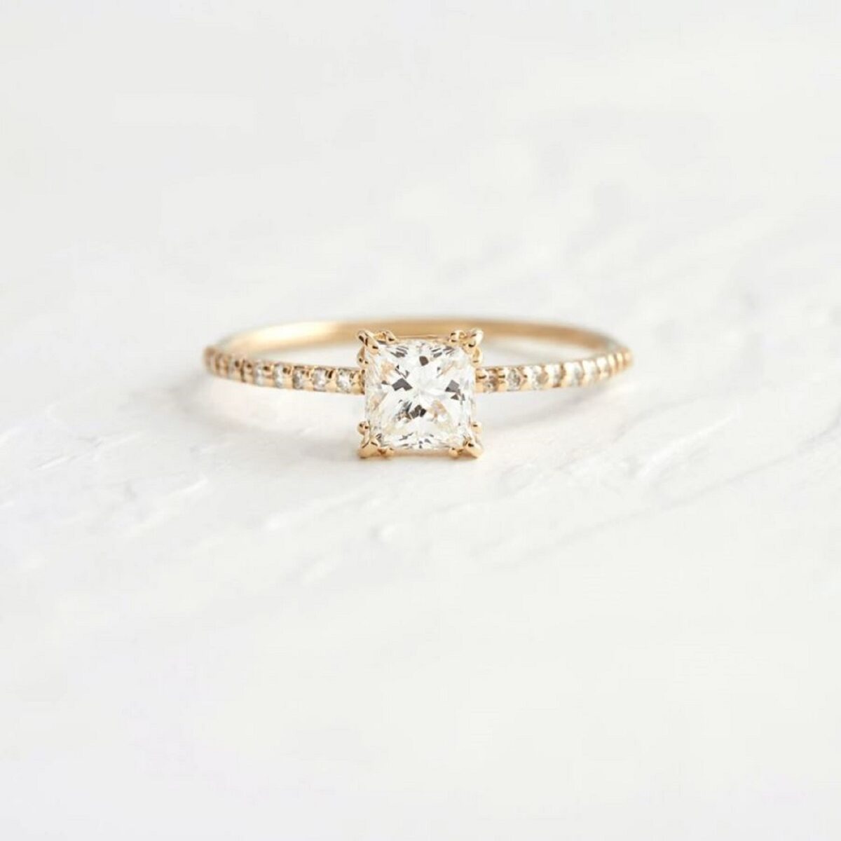 Tiny cushion cut lab grown diamond ring with accent round diamond as pave set on band crafted in 14k yellow gold.