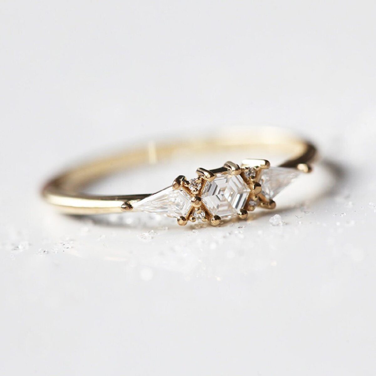 Stylist yet vintage hexagon lab grown diamond ring with accent kite cut diamond three stone ring crafted in 14k yellow gold.