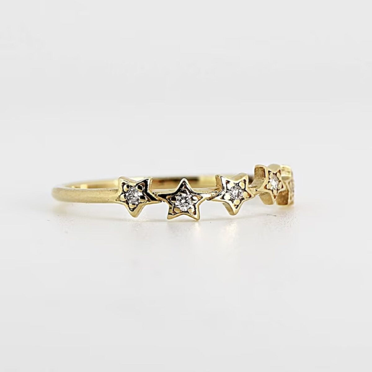 Round cut lab grown diamond star stack ring crafted in 14k yellow gold.