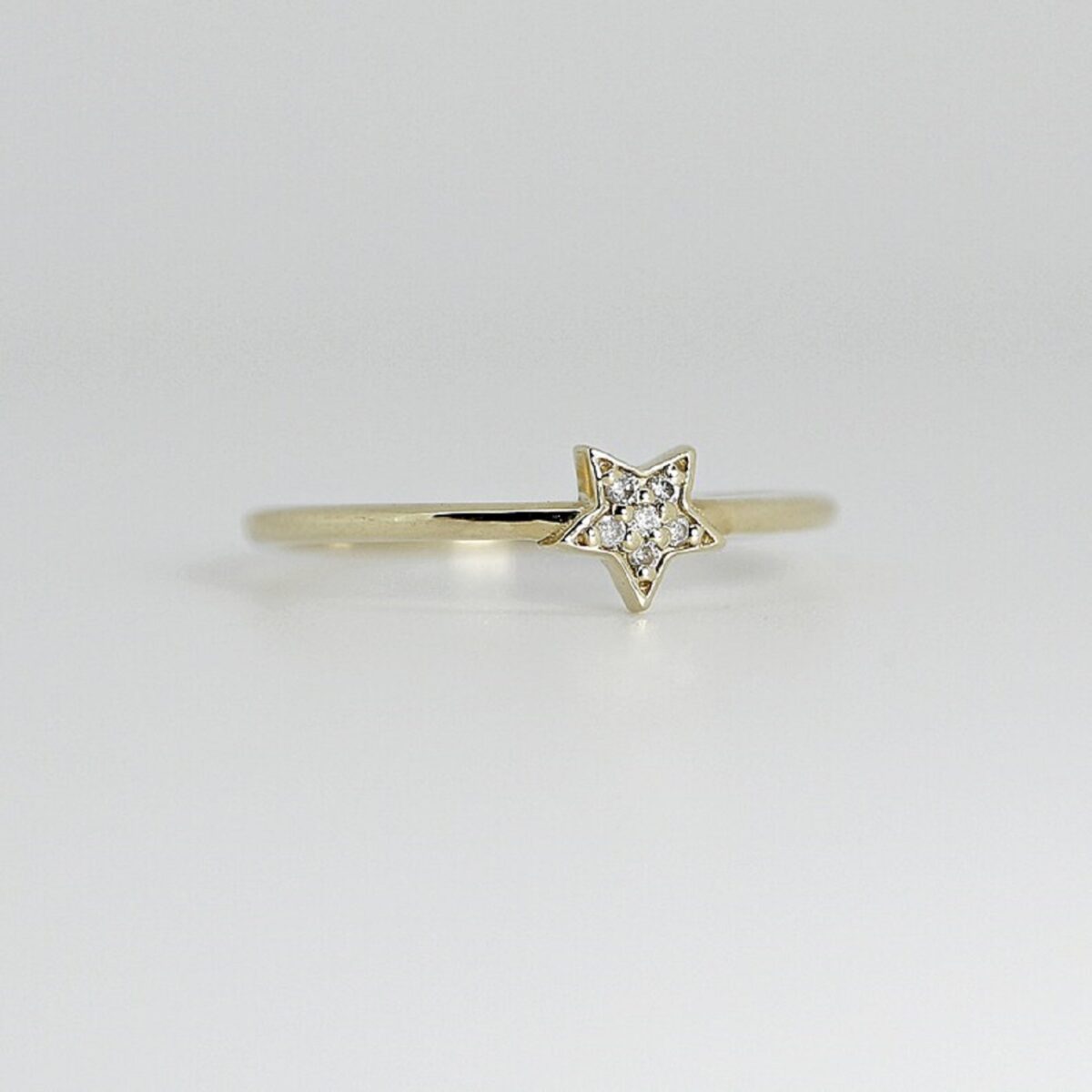 Unique star shaped round cut lab grown diamond statement ring in 14k yellow gold.