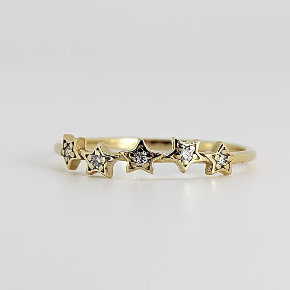 Round cut lab grown diamond star stack ring crafted in 14k yellow gold.