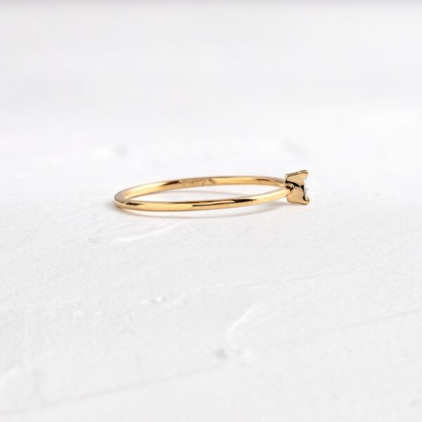 Minimalist style tiny trilliant engagement lab grown diamond ring crafted 14k yellow gold.