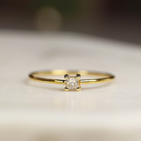 Single cushion lab grown diamond ring crafted in 14k yellow gold.