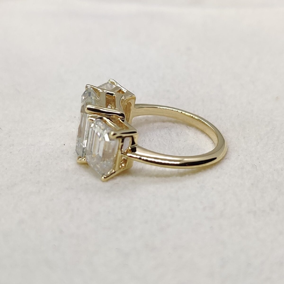 Three stone emerald cut moissanite ring in 14k yellow gold