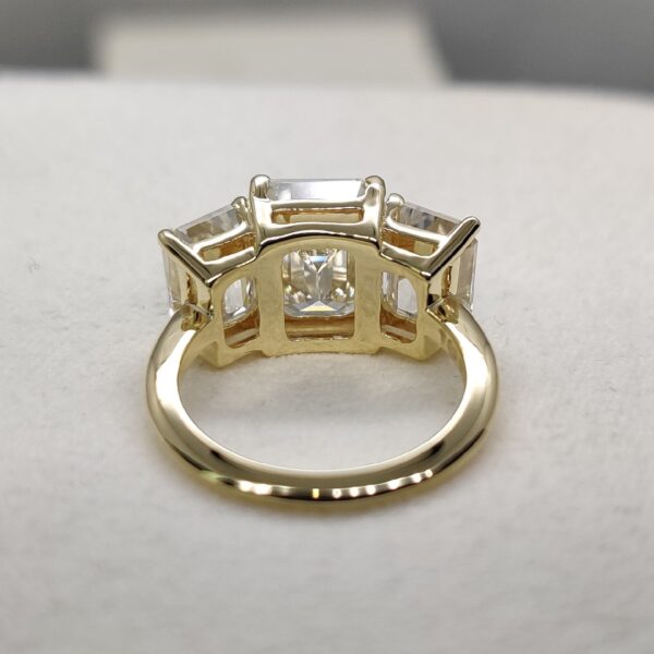 Three stone emerald cut moissanite ring in 14k yellow gold